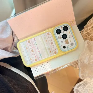 Detail view of yellow iPhone case featuring cute animal illustrations and pastel patterns.