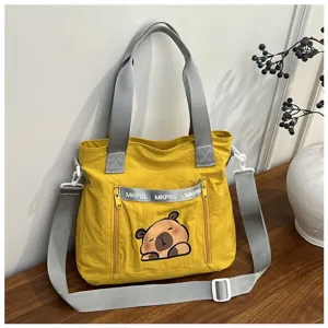 Detailed view of yellow Japanese style cartoon tote bag with cute capybara print