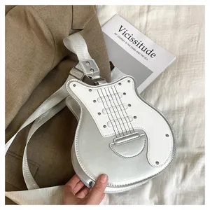 Close-up view of a unique silver and white guitar-shaped crossbody bag with rivets