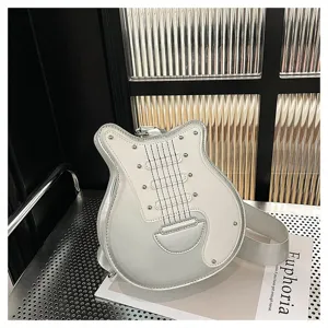 Stylish silver guitar shaped crossbody bag for women in a minimalist indoor setting