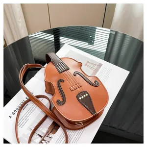 Detailed macro view of a stylish brown violin-shaped crossbody bag on a table