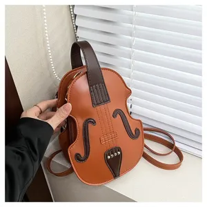 Detailed macro shot of a creative violin-shaped brown leather crossbody bag for women