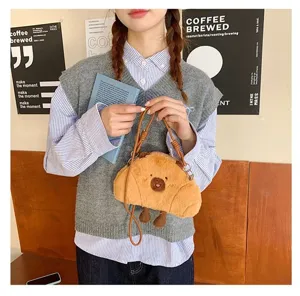 Cute Capybara croissant plush crossbody bag for women and kids in a lifestyle setting.