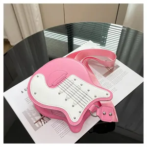 Detailed macro view of a trendy pink guitar-shaped crossbody bag on a white magazine