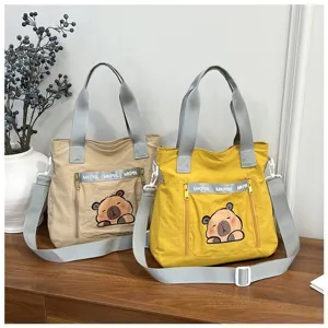 Cute Japanese style cartoon tote bags in khaki and yellow with capybara print detail.