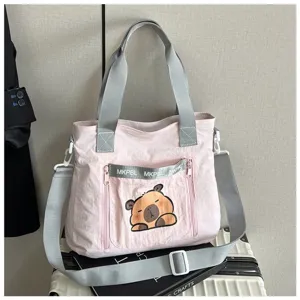 Fashionable pink canvas tote bag featuring a cute cartoon capybara print for students