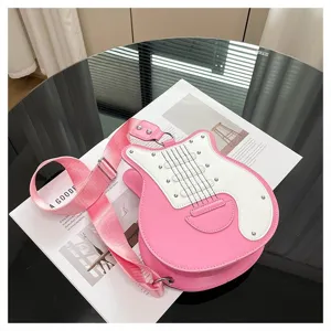 Close-up of a trendy pink guitar-shaped crossbody bag with white faceplate detail.