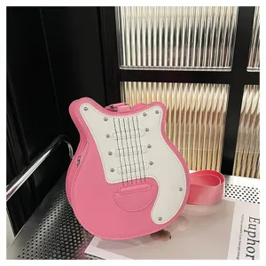 Detail of a pink and white guitar-shaped crossbody bag on a modern chair