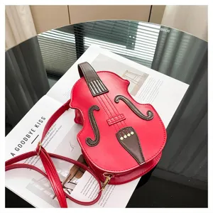 Artistic red violin-shaped crossbody bag for women on a stylish magazine background
