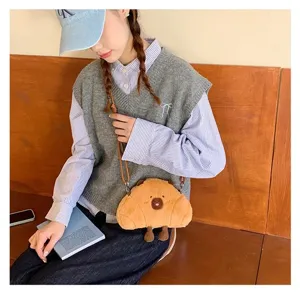 Detailed lifestyle shot of a cute Capybara plush crossbody bag carried by a model.