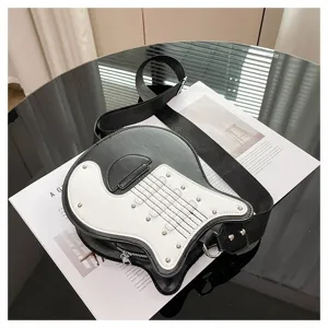 Detail of a creative guitar-shaped crossbody bag with black and white contrast design.