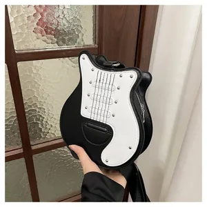 Close-up of a novelty guitar shaped crossbody bag in black and white leather finish