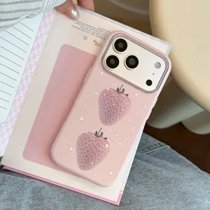 Gros plan sur une coque iPhone rose avec des motifs fraises et de petites étoiles dorées