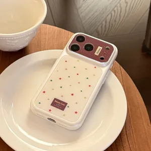 Detail view of iPhone case featuring colorful star patterns and burgundy camera plate