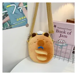Adorable Capybara plush crossbody bag for kids shown in a cozy bedroom setting