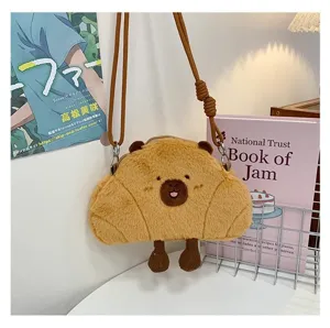 Detail of cute capybara plush crossbody bag in a cozy lifestyle setting