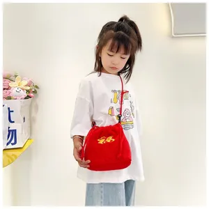Cute red plush lucky bag drawstring crossbody purse for girls shown on a child model