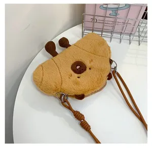 Close-up of a cute plush croissant-shaped crossbody bag with soft fuzzy texture.