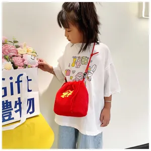 Cute child wearing a vibrant red plush fortune bag with intricate golden embroidery detail.