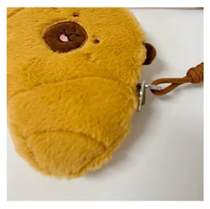 Macro view of soft plush texture and sturdy metal hook on a Capybara crossbody bag