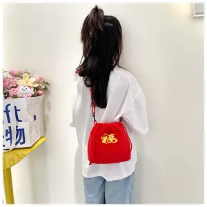 Detailed shot of a child wearing a festive red plush drawstring bag with Fu embroidery