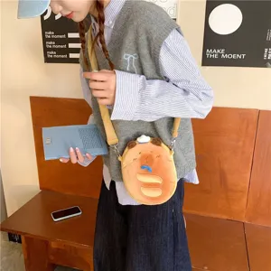 Cute capybara plush crossbody bag shown on a student model in a lifestyle setting.