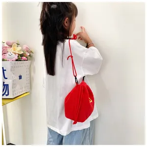 Detailed view of red plush drawstring bag for girls featuring soft faux fur texture