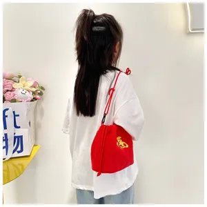 Back view of a young girl wearing a vibrant red plush fortune bag crossbody shoulder bag
