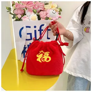 Detail of festive red plush drawstring bag with embroidered Fu character for kids