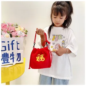 Detailed view of red plush drawstring bag for girls featuring yellow Fu embroidery