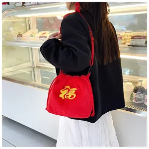 Cute red plush blessing bag with yellow 'Fu' embroidery for girls in a lifestyle setting