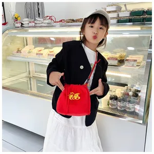 Cute little girl carrying a red plush drawstring bag with Fu embroidery in a bakery
