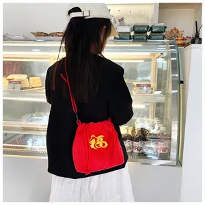 Detailed view of the winter plush red drawstring bag with 'Fu' embroidery