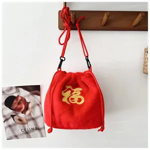 Close-up of red plush drawstring bag with embroidered gold Fu character