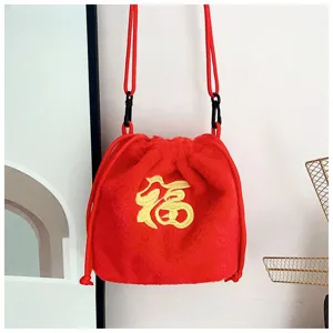 Plush red drawstring crossbody bag with golden 'Fu' character embroidery.