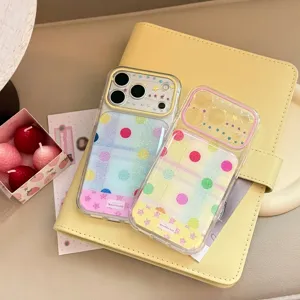 Detailed view of two vibrant transparent phone cases with polka dots and glitter