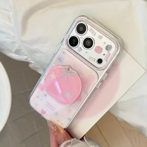 Detail view of sweet pink apple phone case with cute stickers and matching grip stand.