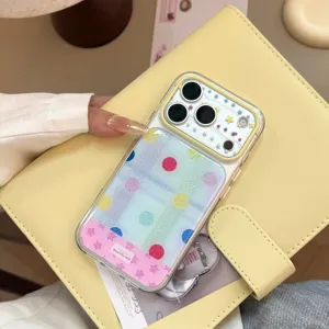 Close-up of colorful collage iPhone case with playful polka dots and star patterns