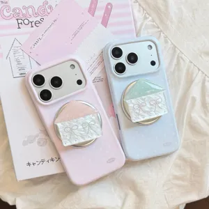 Close-up detail of cute polka dot iPhone cases with house-shaped magnetic grips in soft pastel colors