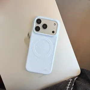 Light blue polka dot magnetic phone case presented on a silver laptop surface with natural light