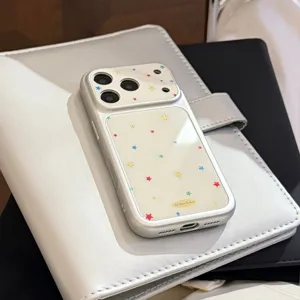 Macro view of cream iPhone case with colorful star patterns and gold accents