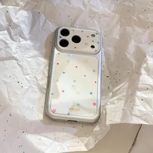 Close-up detail of silver phone case with colorful star patterns on white reflective back