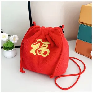 Close-up detail of a red plush lucky bag crossbody purse with gold Fu embroidery design