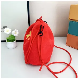 Detail of red plush drawstring crossbody bag with soft fuzzy texture