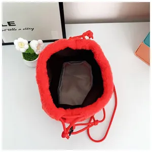 Macro view of the interior lining and drawstring closure of a red plush lucky bag