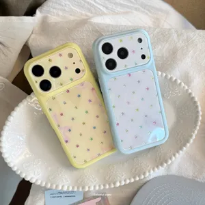 Aesthetic detail view of iPhone cases with colorful star patterns on a white ceramic tray