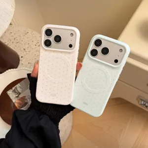 Gros plan sur deux coques iPhone MagSafe en blanc et menthe avec motifs à pois