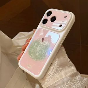 Close-up of glittery pink iPhone case with green apple illustration detail