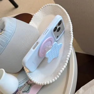 Gros plan d'une coque iPhone bleu clair avec support en forme d'étoile et anneau magnétique.