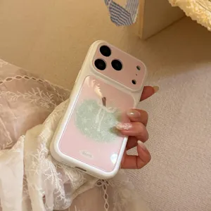 Close-up view of a cream iPhone case featuring a sparkly green apple on pink